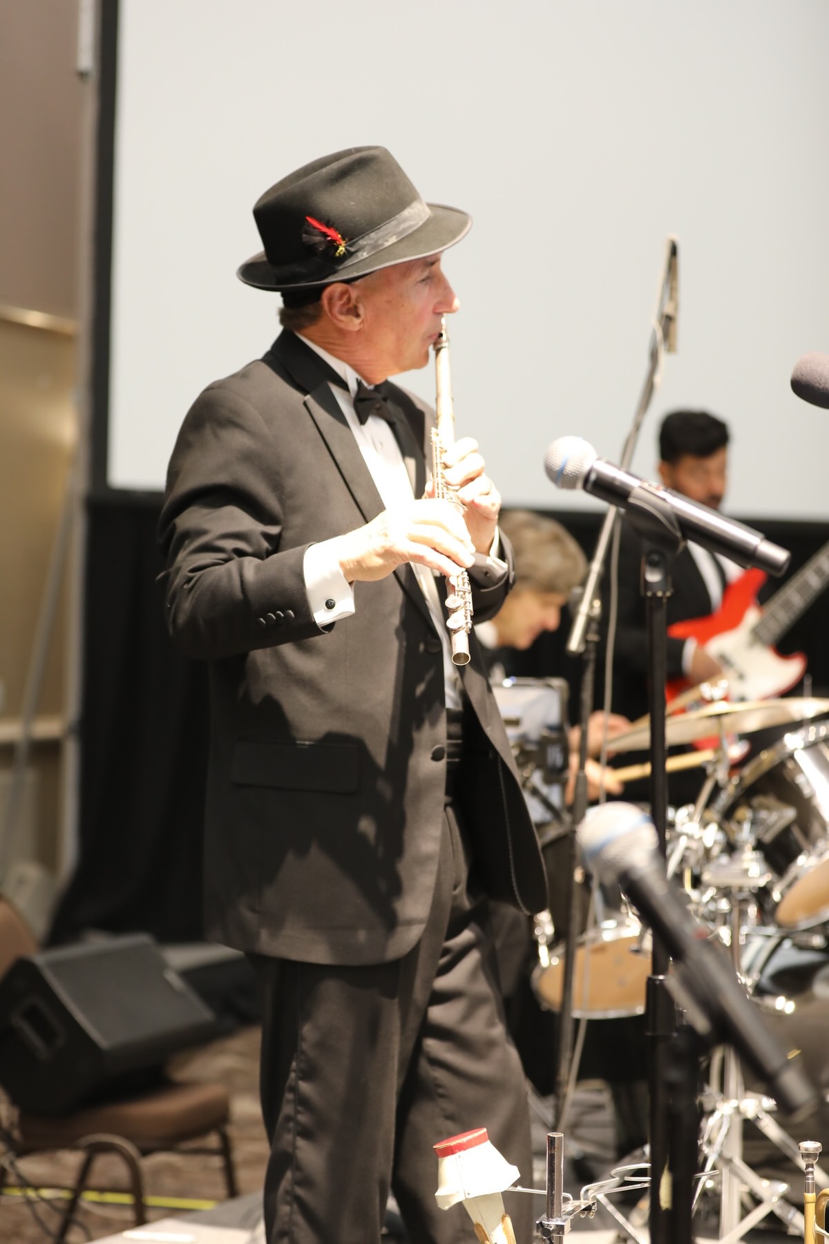 Band performing on stage for formally dressed guests at a gala