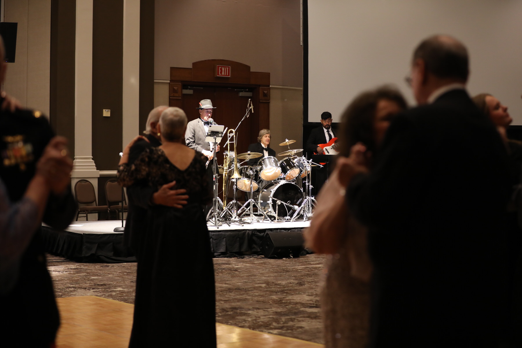 Big band setup with brass and rhythm section at an evening event